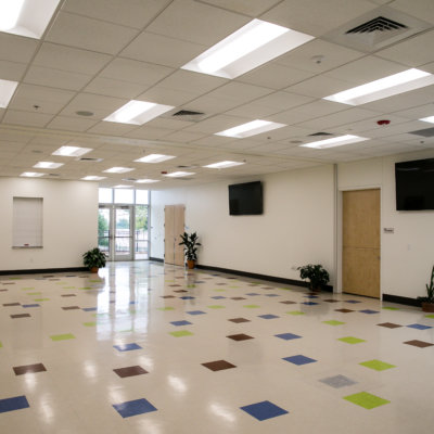 An empty room with colorful tile on the floor.