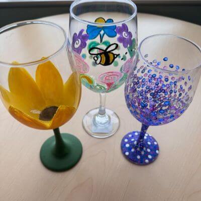 A display of hand-painted wine glasses of various designs.