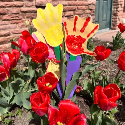 A custom bouquet made by hand is located in a flower bed.
