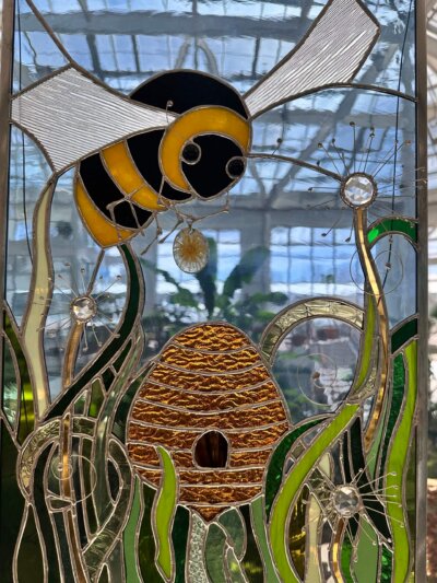 Stained Glass bee and hive in grass