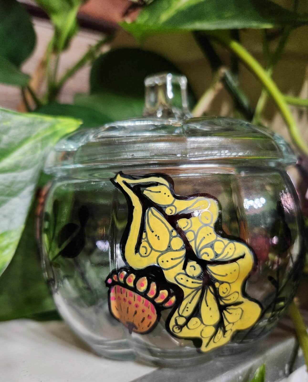 Glass pumpkin candy jar with a drawing
