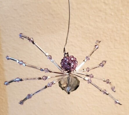 A beaded spider hanging from a wire